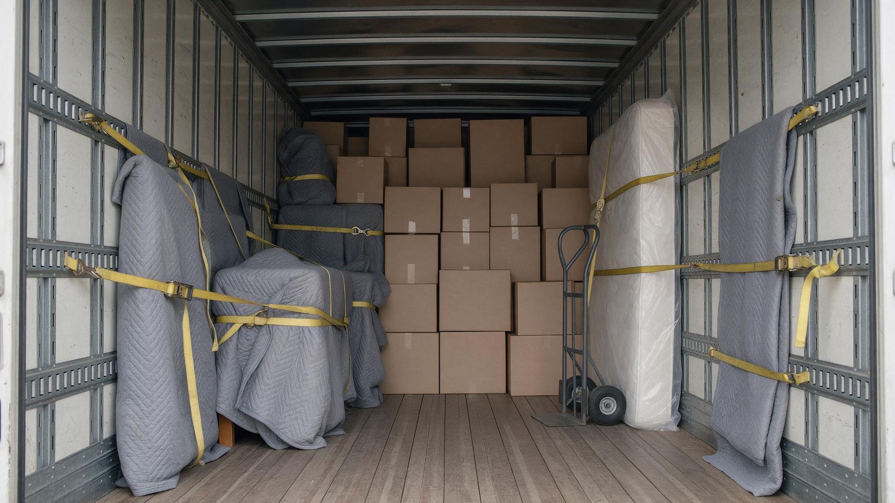 Loaded moving truck with furniture strapped to the walls